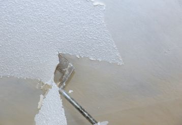 Outdated popcorn ceiling in need of a makeover - explore modern alternatives for a fresh and stylish home design.